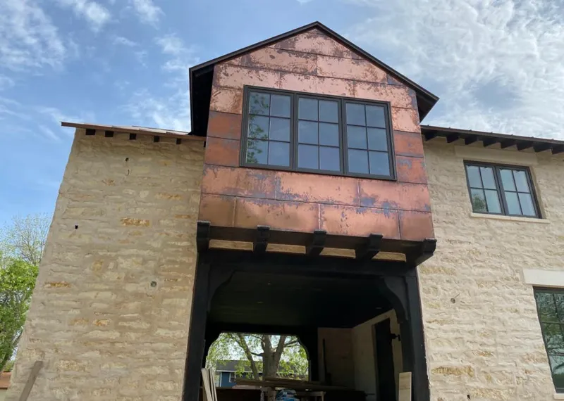 Copper metal panel facade on a stone building for Skylight Installation in Decatur